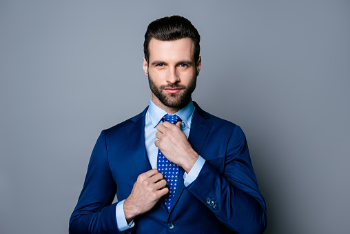 portrait-of-serious-fashionable-handsome-man-posing-in-blue-suit-tie-picture-id942796846
